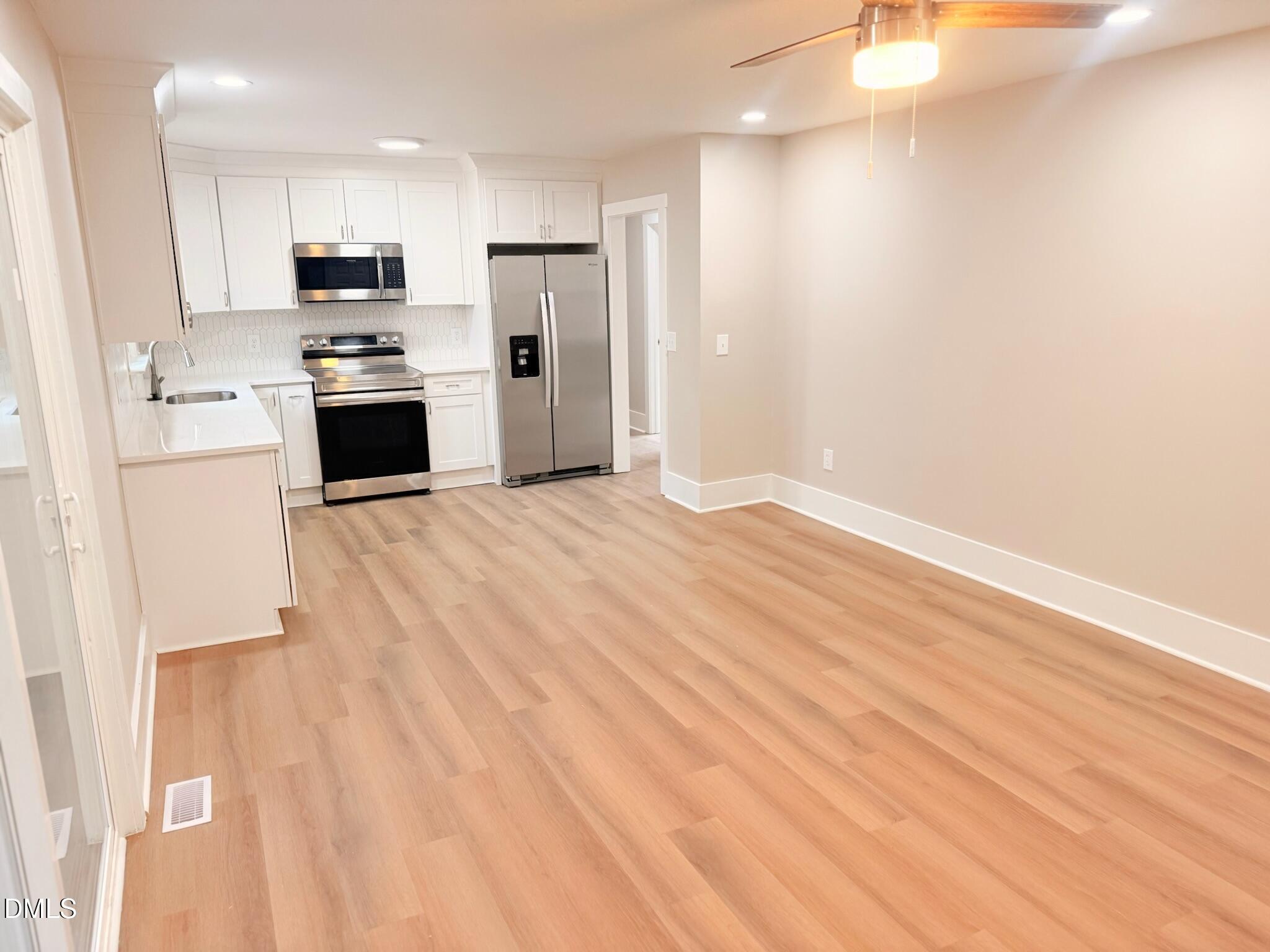 1209 Snow Hill Road Durham, NC 27712 - Photo 6 of 14 a view of kitchen with wooden floor and electronic appliances