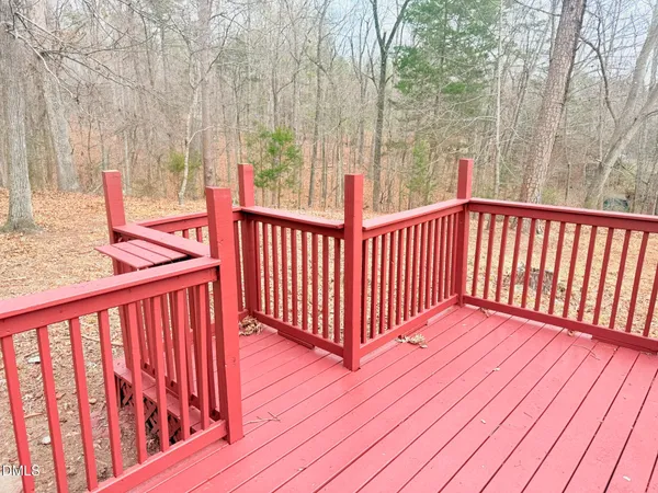 a view of balcony with wooden floor and fence