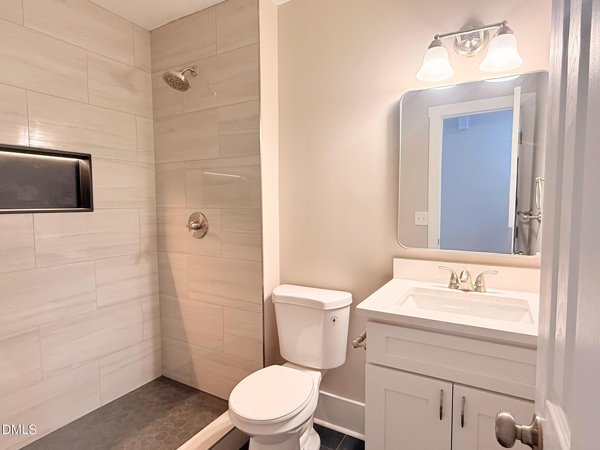 1209 Snow Hill Road Durham, NC 27712 - Photo 9 of 14 a bathroom with a sink a toilet and shower
