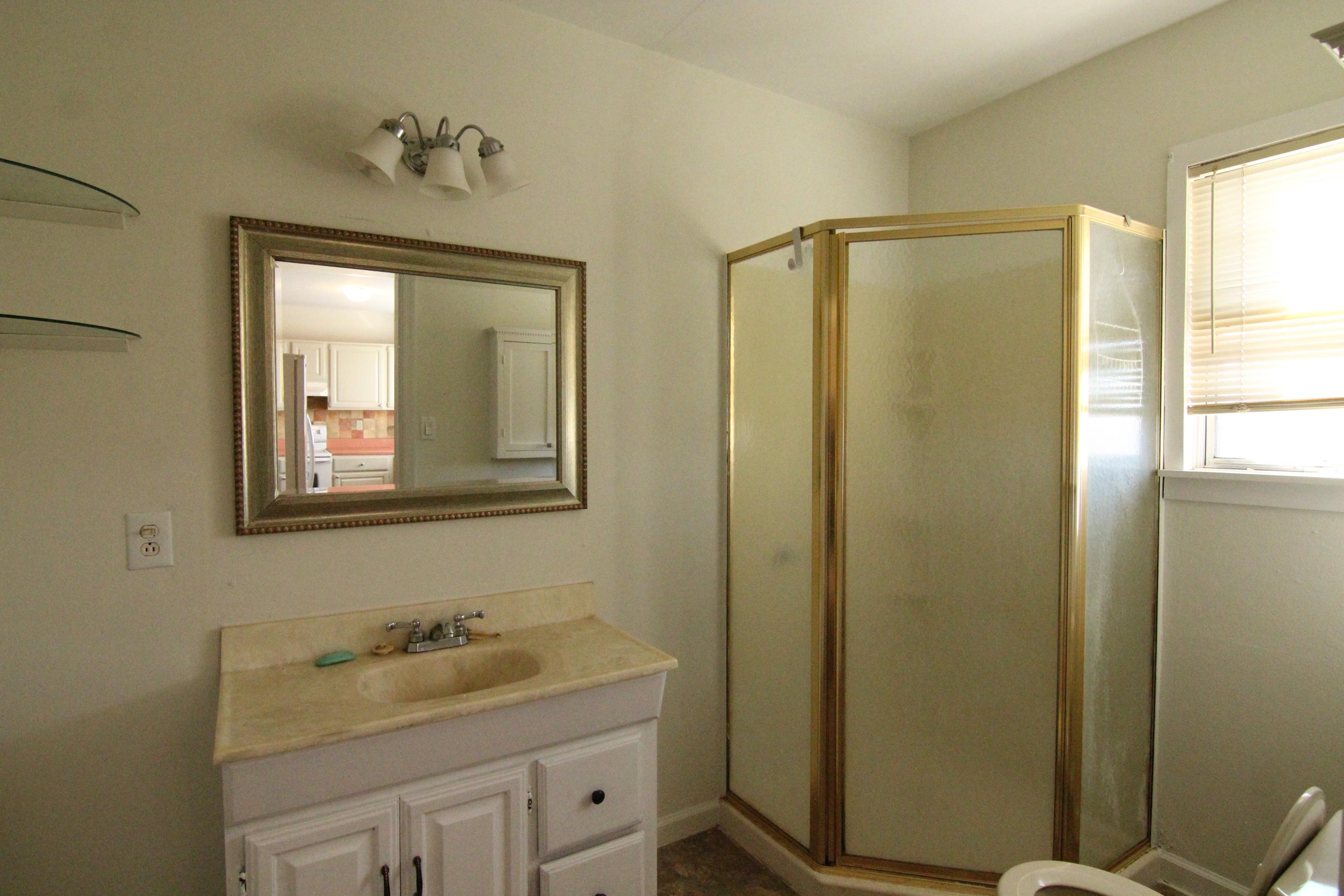 1063 Pep Hill Road Goodview, VA 24095 - Photo 12 of 27 a bathroom with 2 sink toilet and a mirror