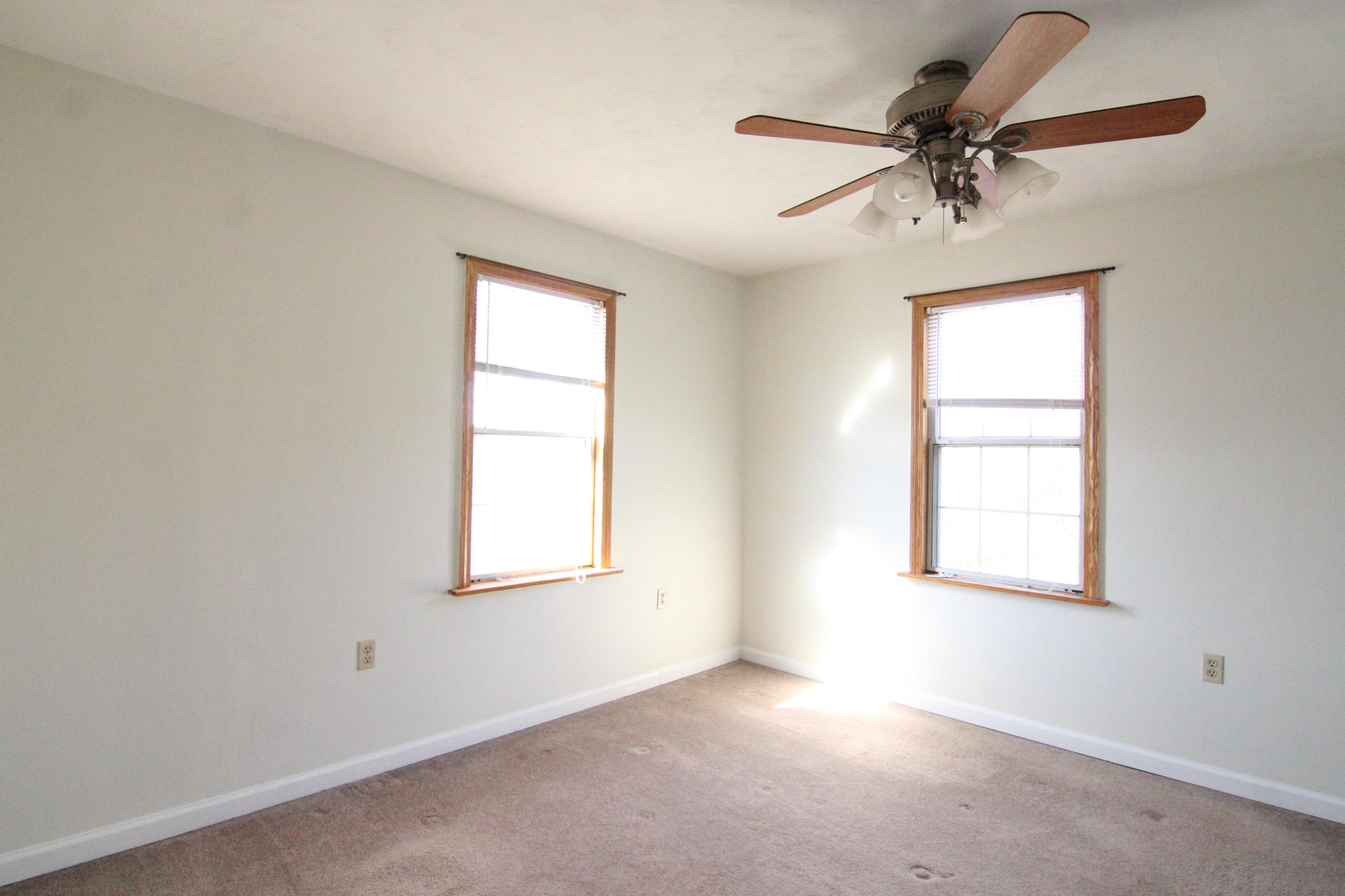 1063 Pep Hill Road Goodview, VA 24095 - Photo 17 of 27 an empty room with a window and a fan