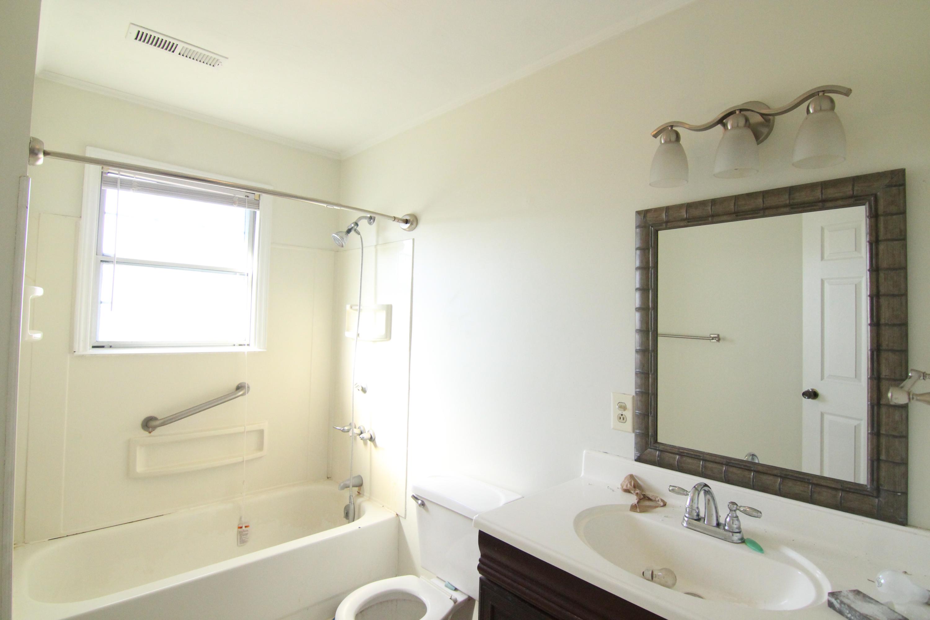1063 Pep Hill Road Goodview, VA 24095 - Photo 18 of 27 a bathroom with a sink mirror toilet and bathtub