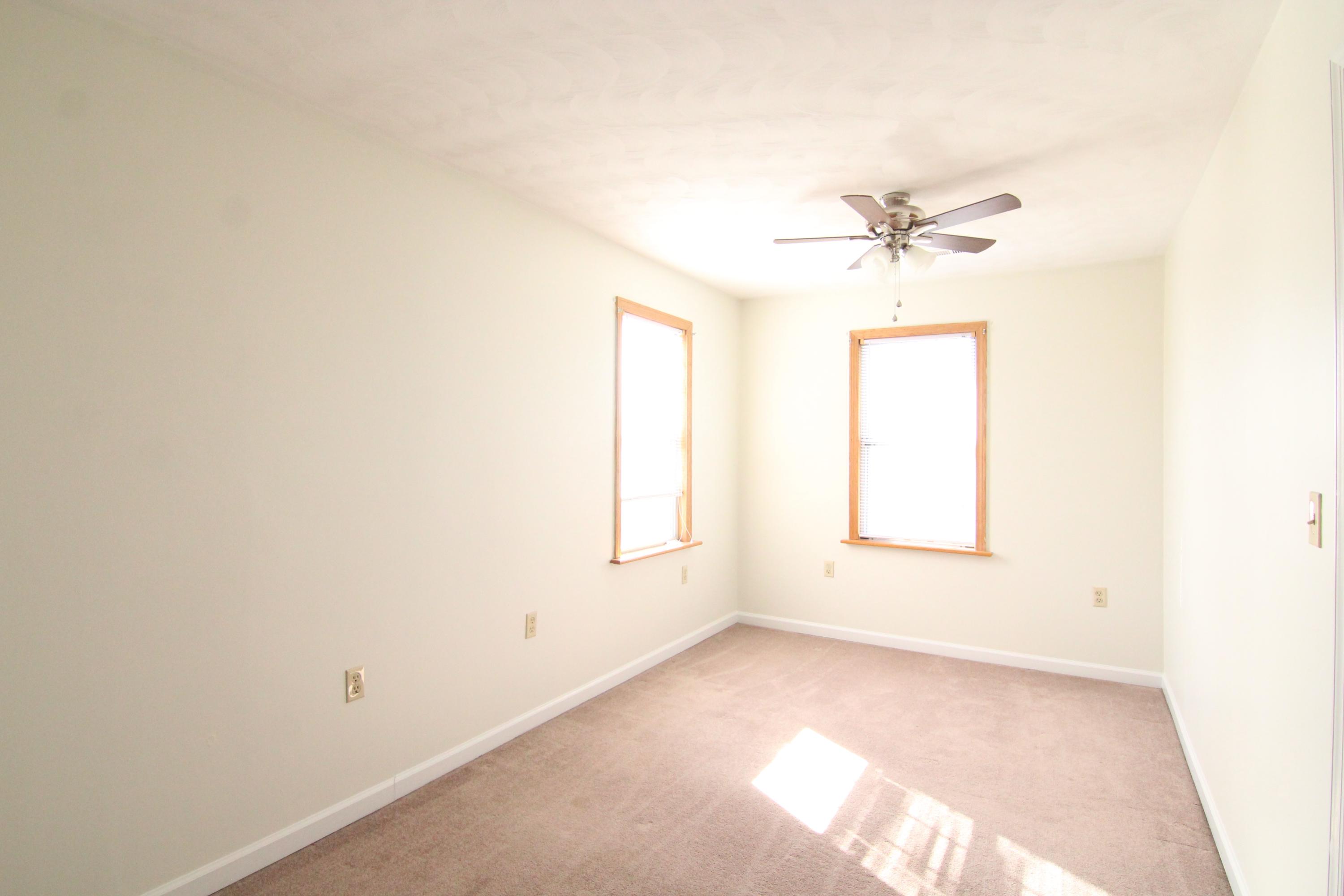 1063 Pep Hill Road Goodview, VA 24095 - Photo 20 of 27 an empty room with a window and a ceiling fan