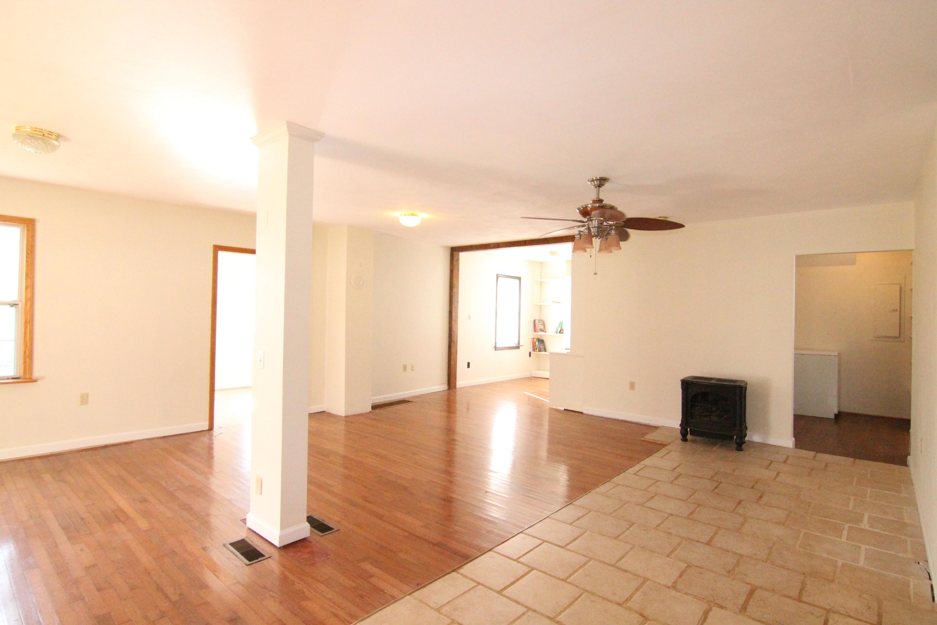 1063 Pep Hill Road Goodview, VA 24095 - Photo 3 of 27 a view of a hallway with wooden floor and a bathroom