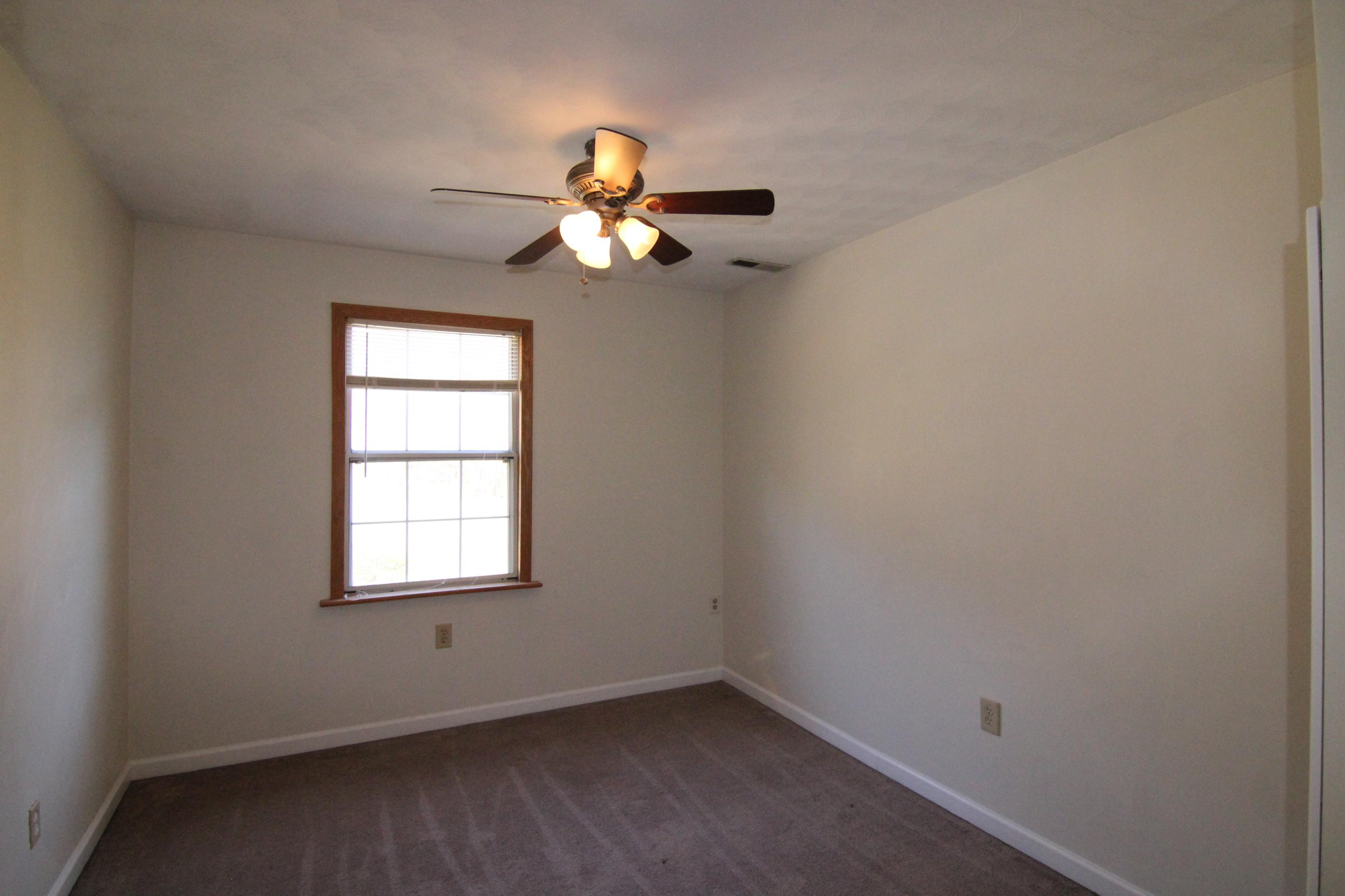 1063 Pep Hill Road Goodview, VA 24095 - Photo 22 of 27 an empty room with windows and fan