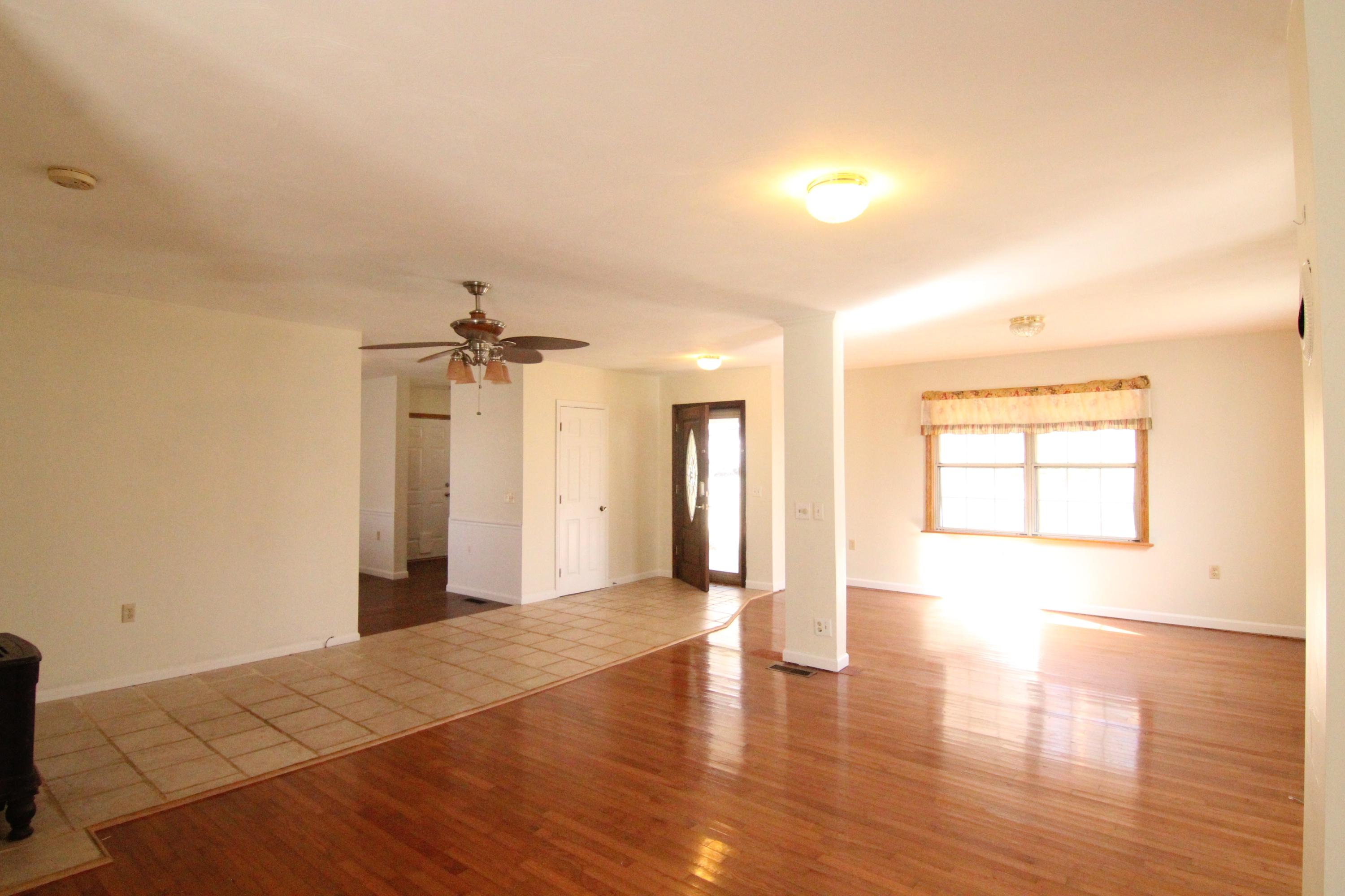 1063 Pep Hill Road Goodview, VA 24095 - Photo 5 of 27 a view of an empty room with window and wooden floor