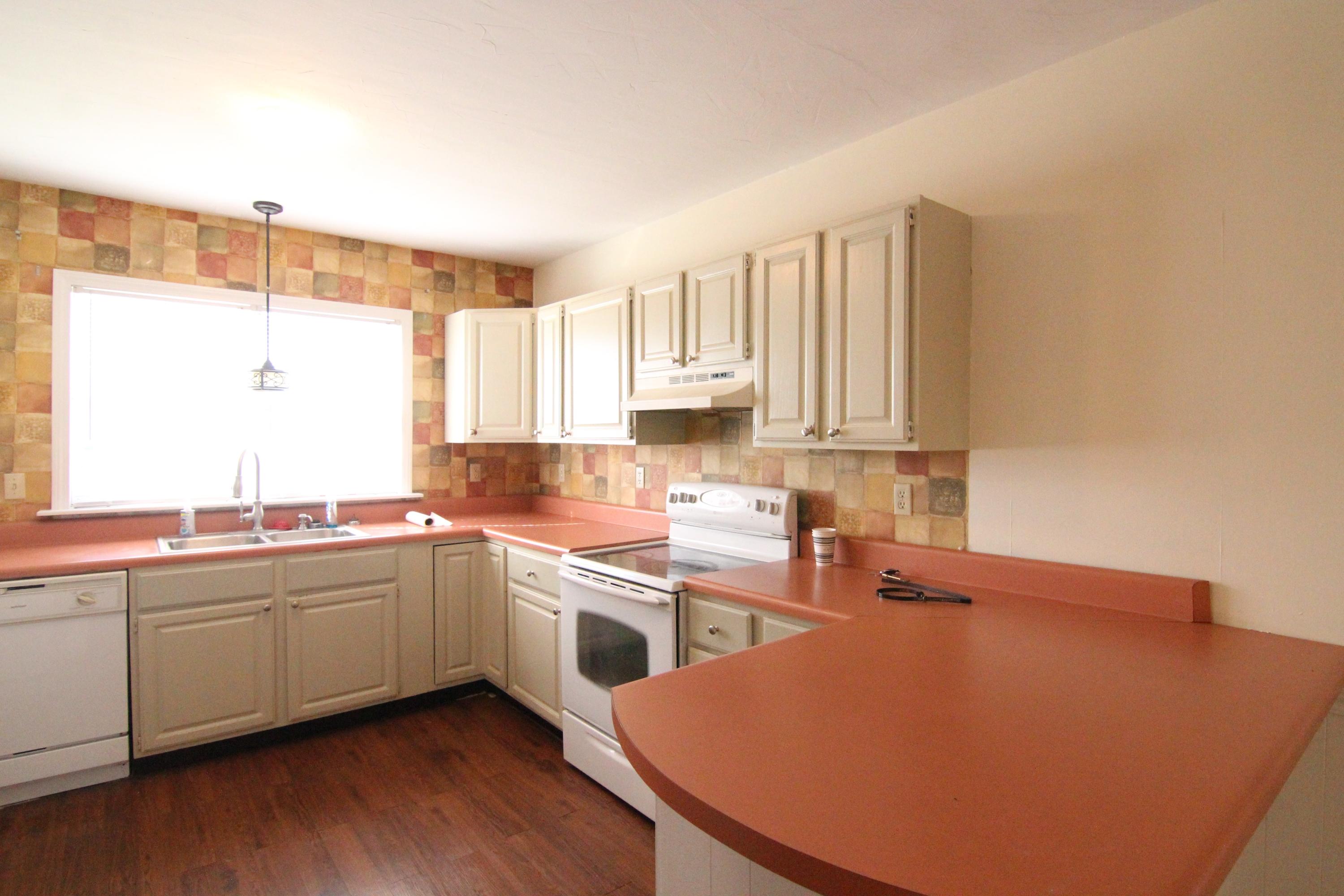 1063 Pep Hill Road Goodview, VA 24095 - Photo 6 of 27 a kitchen with stainless steel appliances a sink a stove a refrigerator cabinets and a window