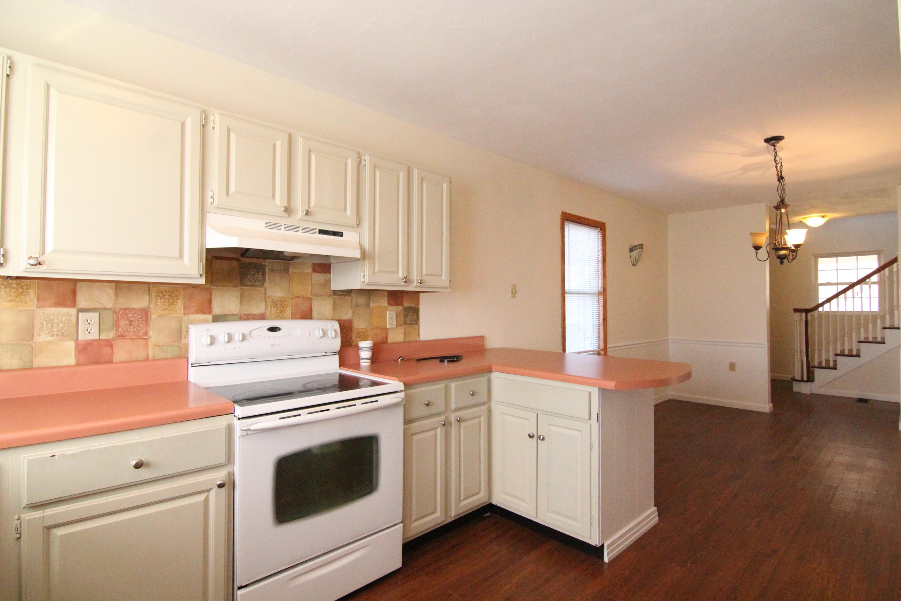 1063 Pep Hill Road Goodview, VA 24095 - Photo 8 of 27 a kitchen with stainless steel appliances white cabinets and a stove