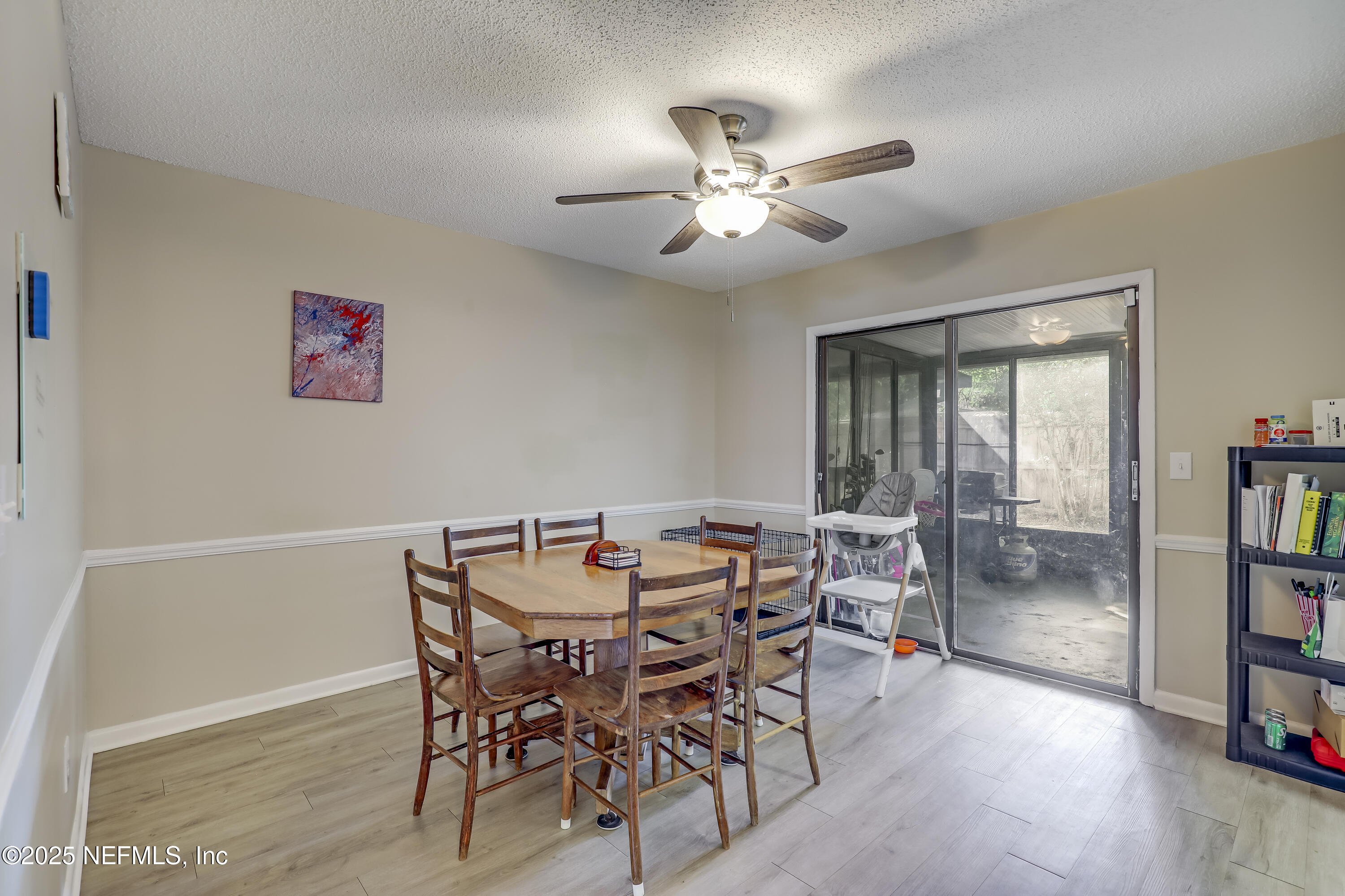 503 Kettering Way Orange Park, FL 32073 - Photo 11 of 28 a view of a dining room with furniture and a book shelf
