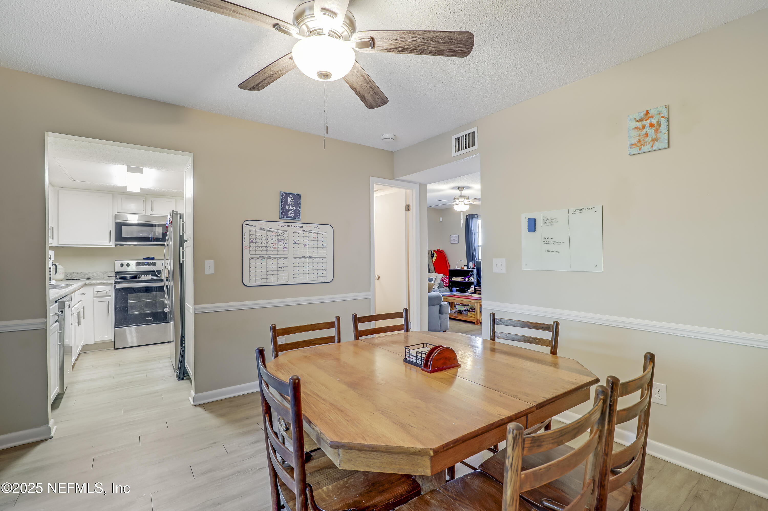503 Kettering Way Orange Park, FL 32073 - Photo 12 of 28 a view of a dining room with furniture and a chandelier fan