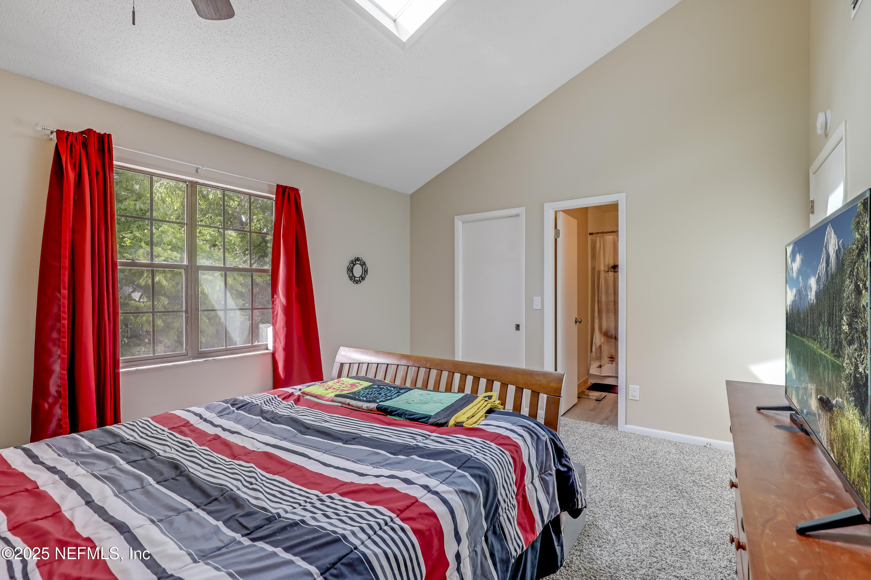 503 Kettering Way Orange Park, FL 32073 - Photo 23 of 28 a bedroom with a bed and a flat screen tv