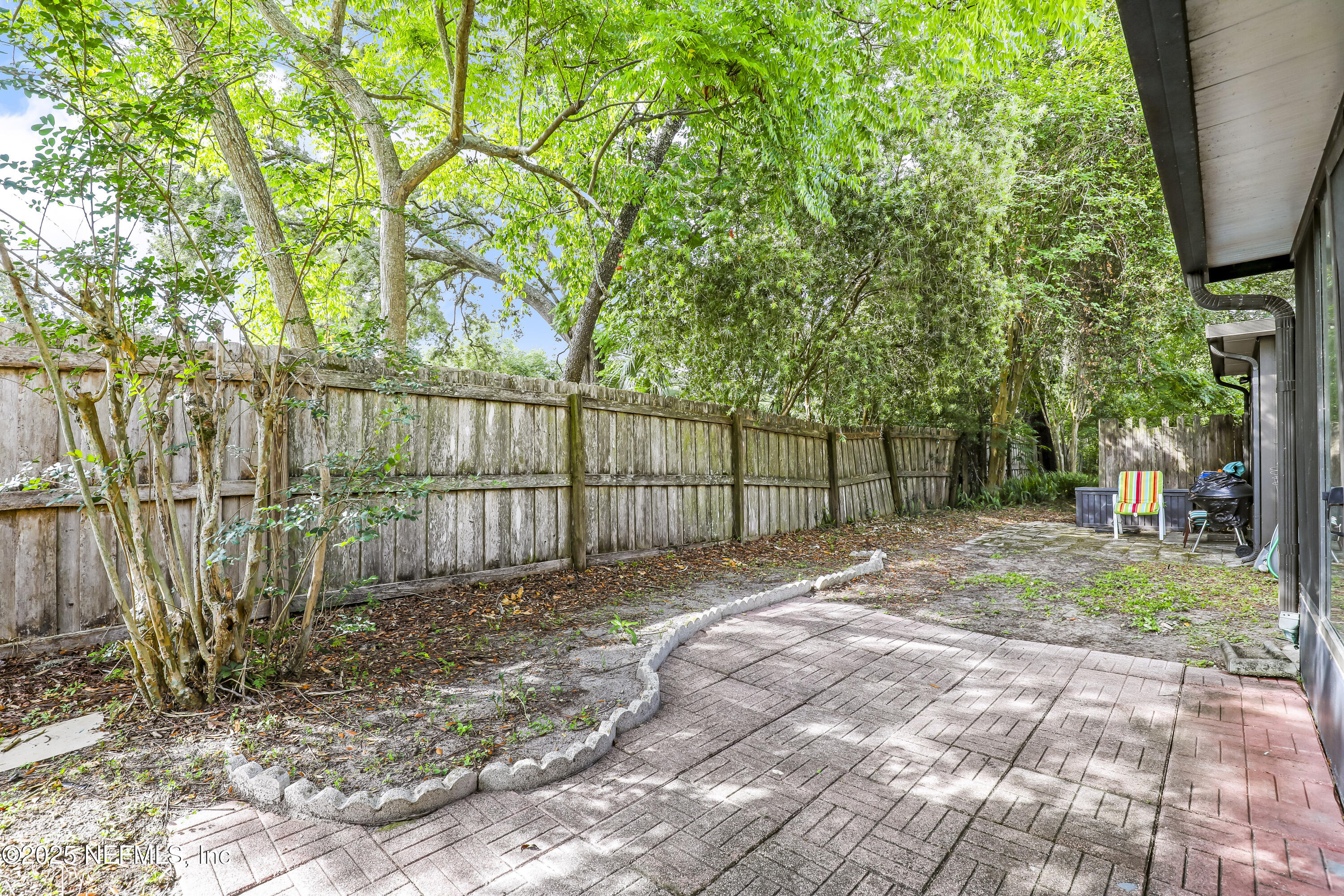 503 Kettering Way Orange Park, FL 32073 - Photo 26 of 28 a view of a backyard with large trees and wooden fence