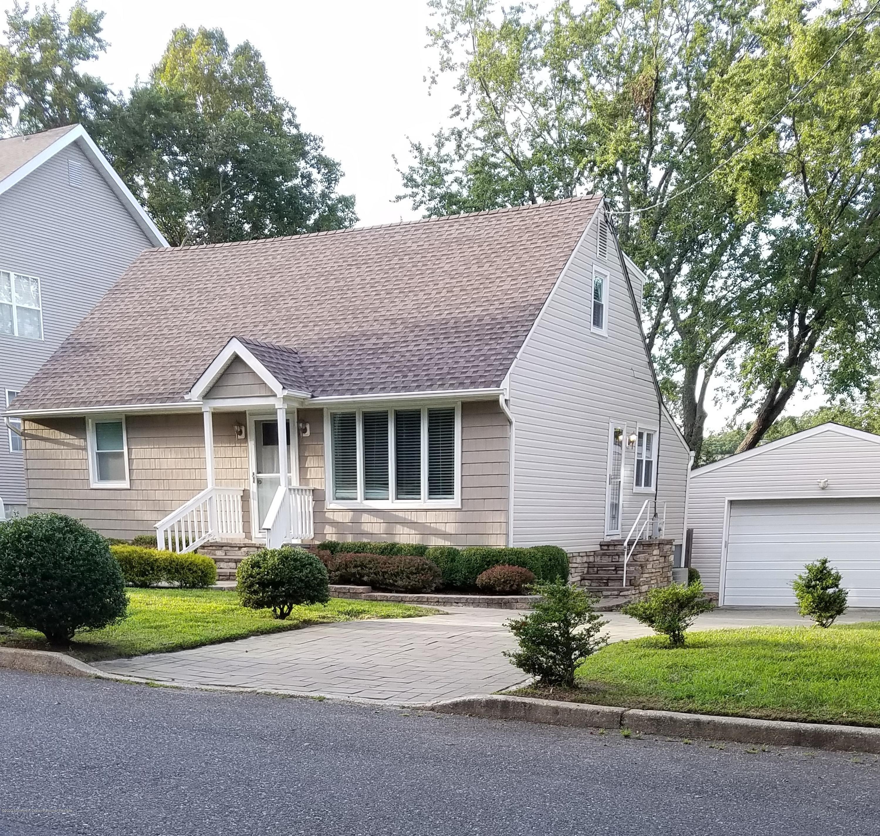 213 Wilson Road Neptune Township, NJ 07753 - Photo 1 of 1 a front view of a house with a garden and plants
