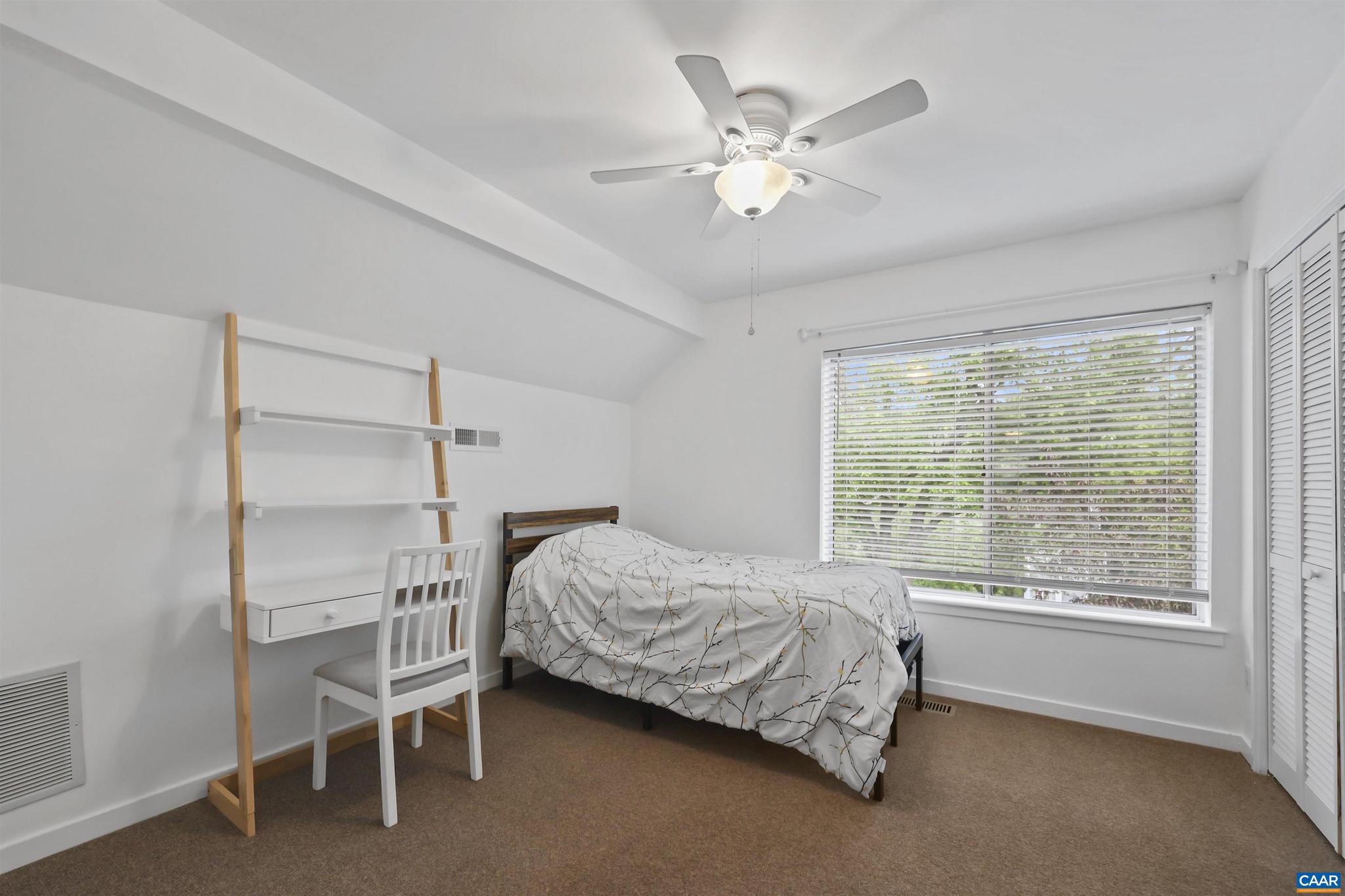 1250 Maple View Drive Charlottesville, VA 22902 - Photo 14 of 25 a bedroom with a bed and a chandelier