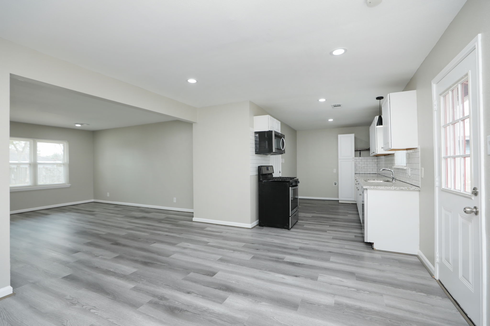 9211 Vinearbor Street Houston, TX 77033 - Photo 11 of 33 a view of kitchen with wooden floor