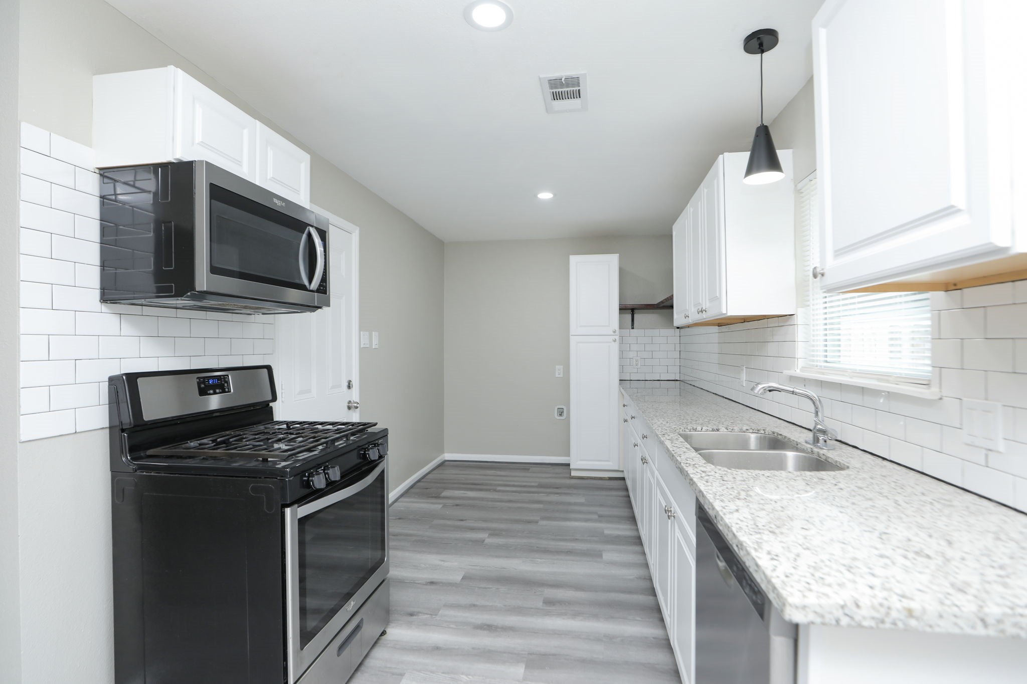 9211 Vinearbor Street Houston, TX 77033 - Photo 14 of 33 a kitchen with granite countertop stainless steel appliances and a sink