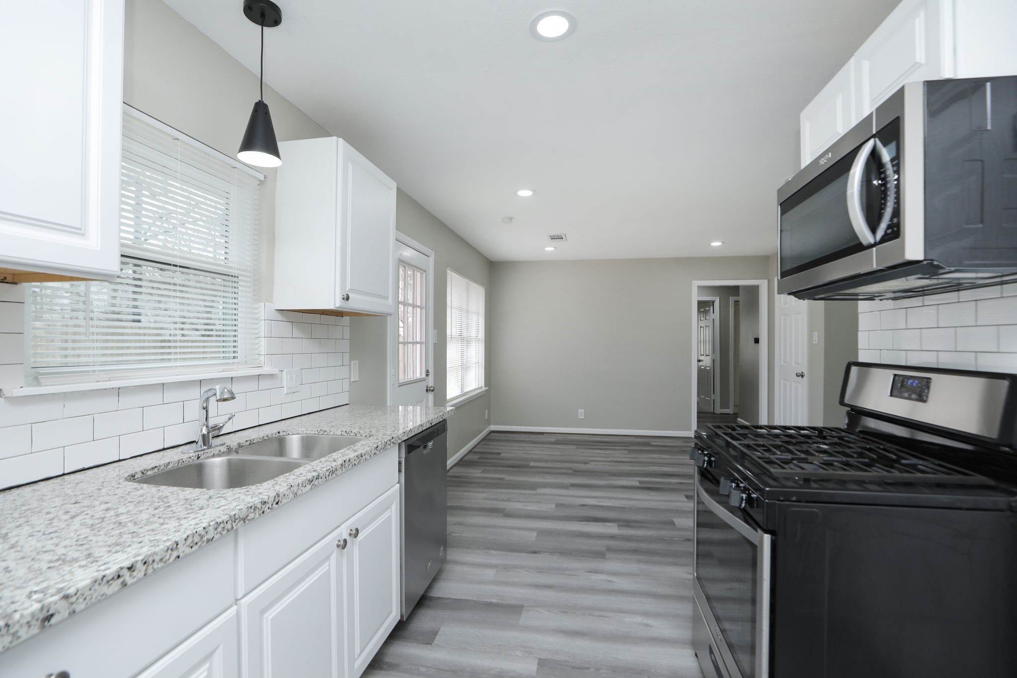 9211 Vinearbor Street Houston, TX 77033 - Photo 17 of 33 a kitchen with stainless steel appliances granite countertop a sink and a stove