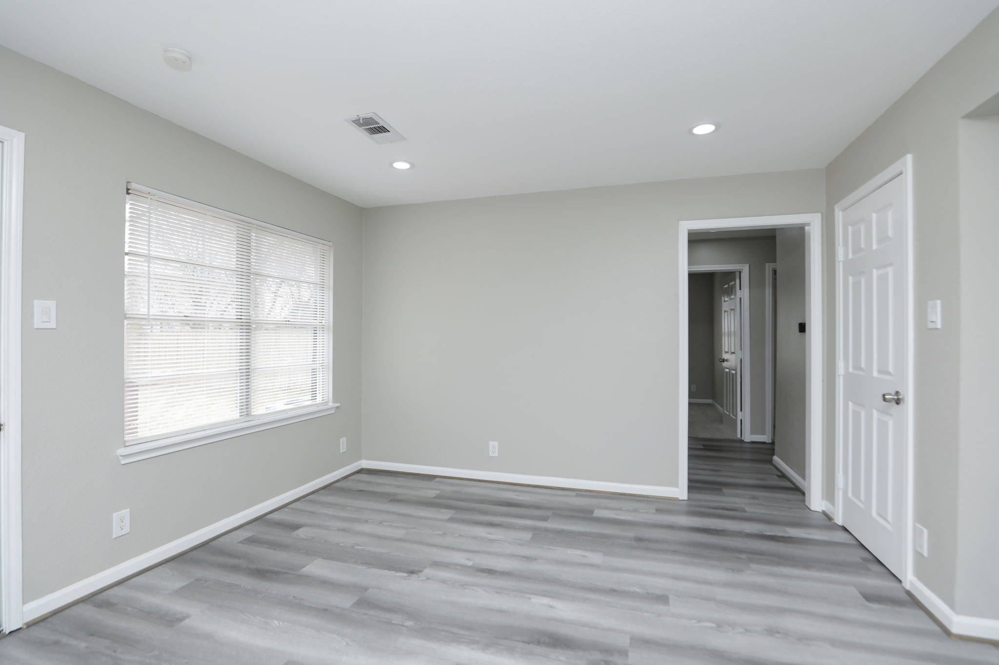 9211 Vinearbor Street Houston, TX 77033 - Photo 18 of 33 wooden floor in an empty room with a window