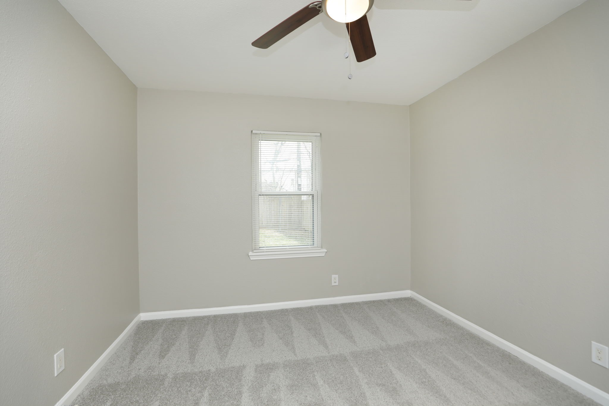 9211 Vinearbor Street Houston, TX 77033 - Photo 20 of 33 an empty room with a window and a fan