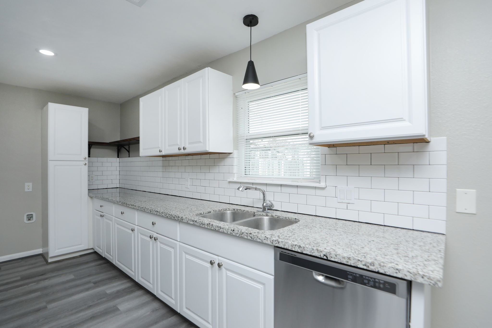 9211 Vinearbor Street Houston, TX 77033 - Photo 2 of 33 a kitchen with granite countertop a sink stainless steel appliances and cabinets