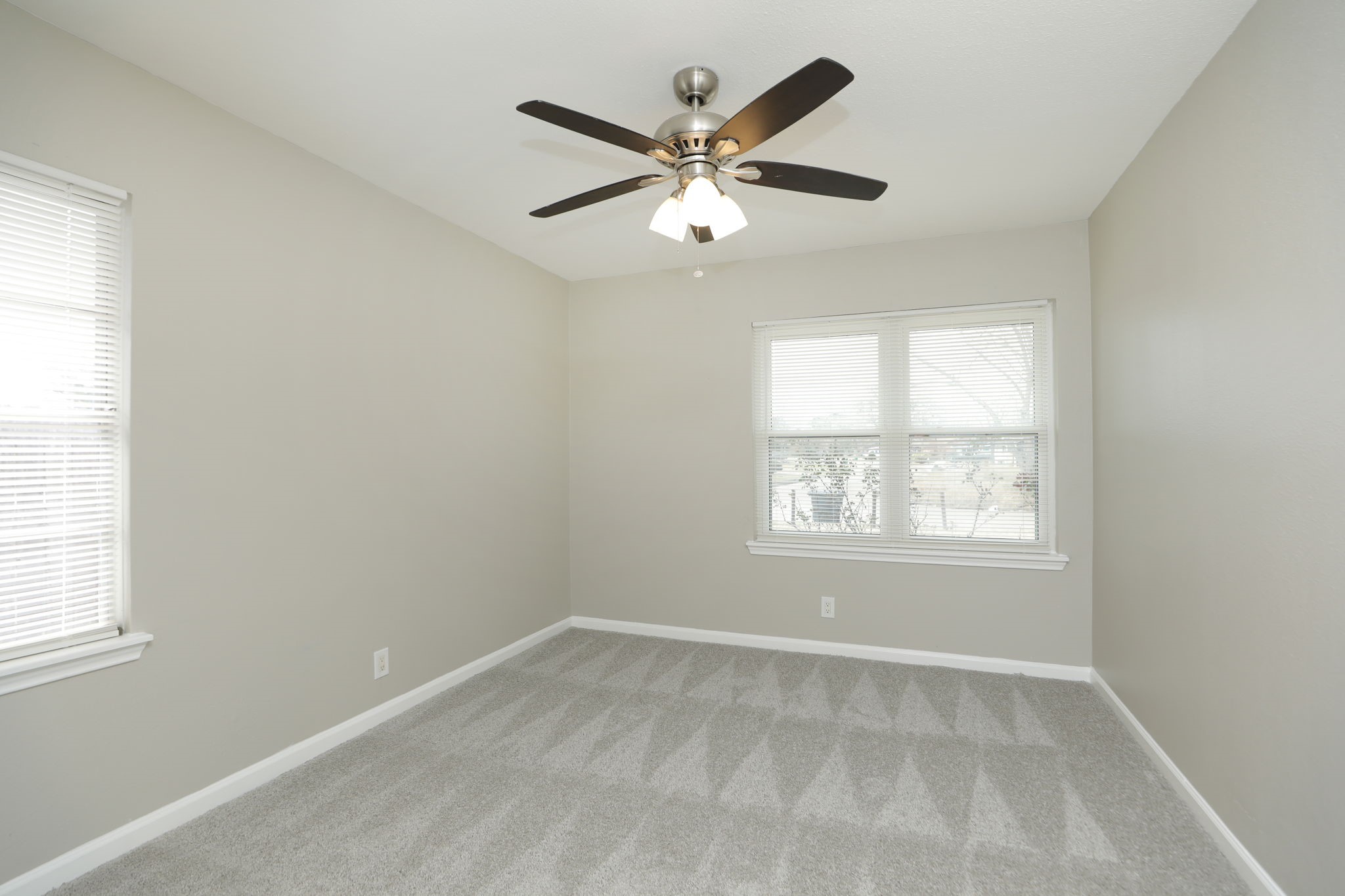9211 Vinearbor Street Houston, TX 77033 - Photo 22 of 33 an empty room with a window and a fan