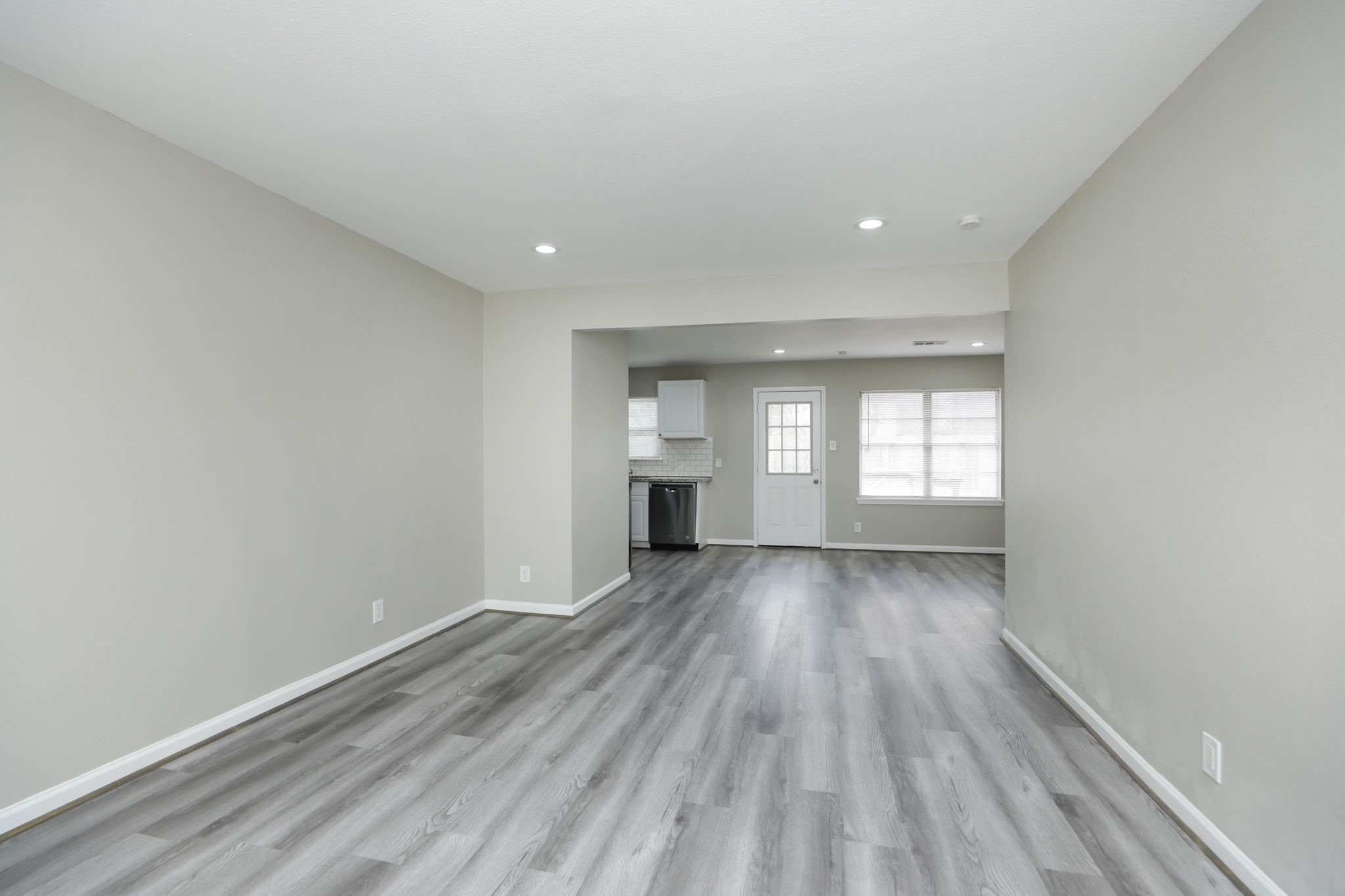 9211 Vinearbor Street Houston, TX 77033 - Photo 5 of 33 wooden floor in an empty room with a window