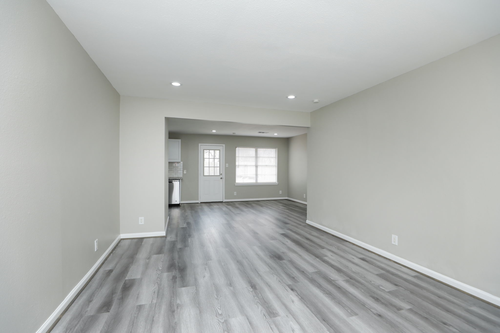 9211 Vinearbor Street Houston, TX 77033 - Photo 7 of 33 wooden floor in an empty room with a window