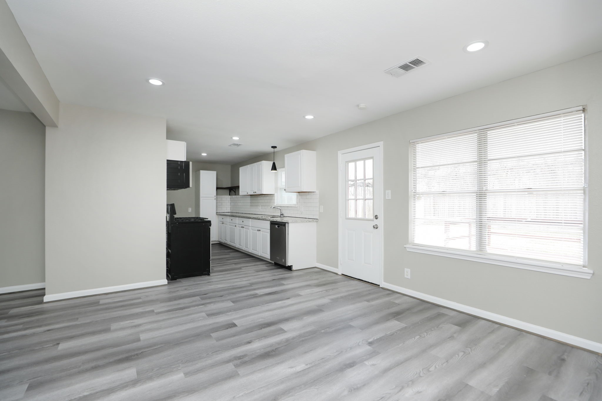 9211 Vinearbor Street Houston, TX 77033 - Photo 10 of 33 a view of kitchen with wooden floor