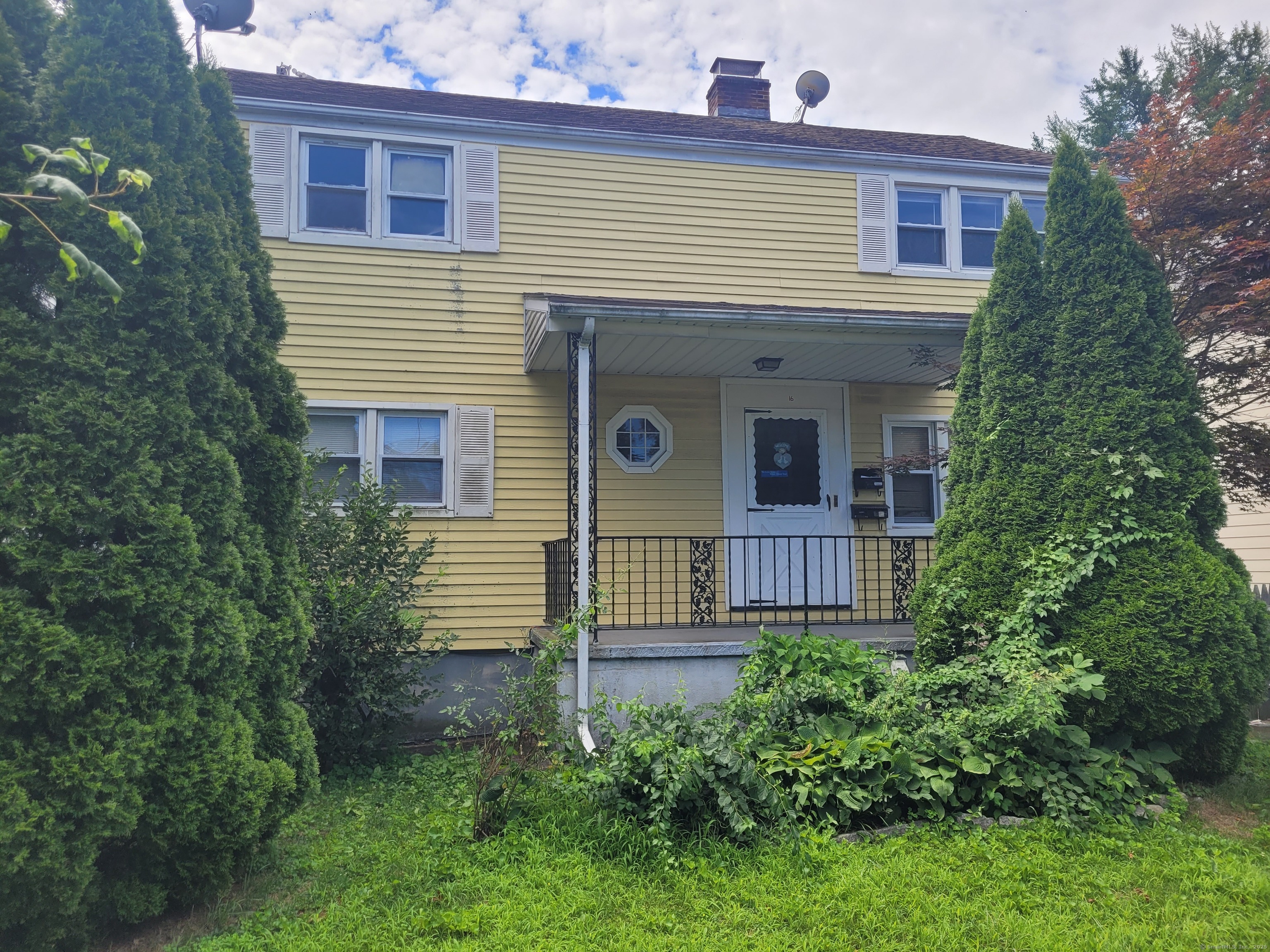 a front view of a house with a garden