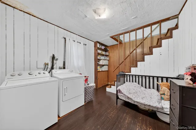 a view of utility room and utility room with wooden floor and windows