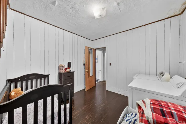 a bedroom with furniture and a wooden floor
