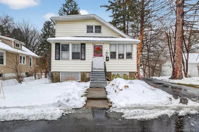 a view of a white house with large windows