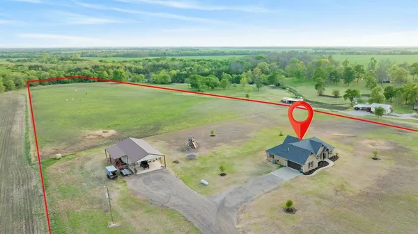 an aerial view of a house with a yard