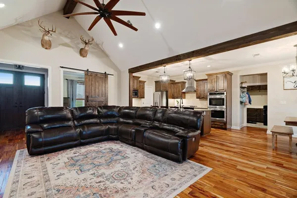a living room with furniture and a wooden floor