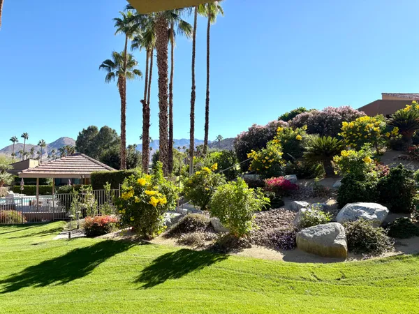 a front view of a house with a yard and outdoor seating