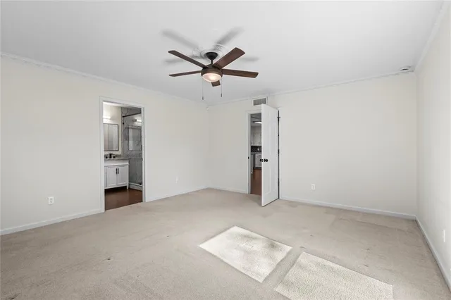 an empty room with closet and windows