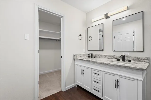 a bathroom with a double vanity sink and mirror
