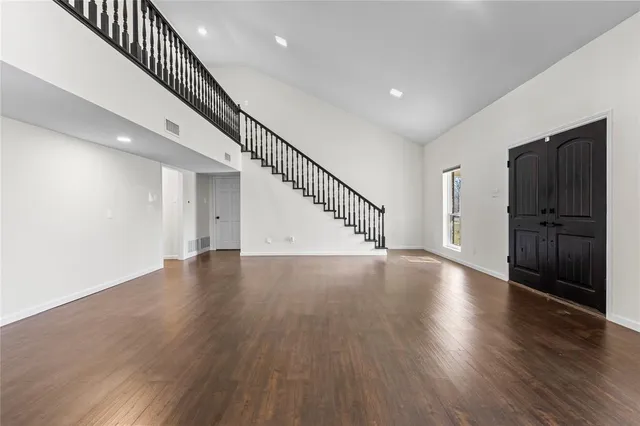 a view of an entryway with wooden floor