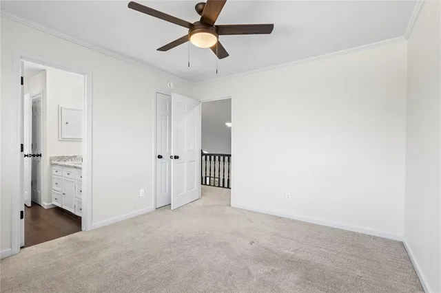 an empty room with a ceiling fan and closet