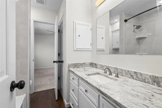 a bathroom with a granite countertop sink