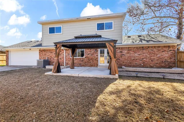 a view of a house with a wooden fence