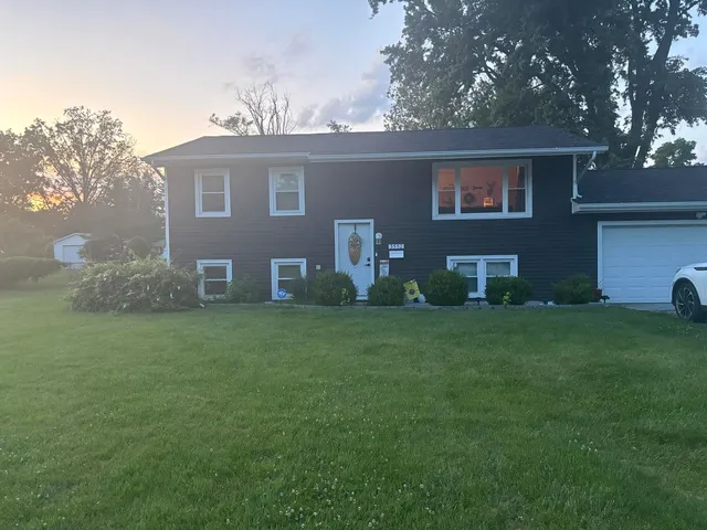 a front view of house with yard and seating area