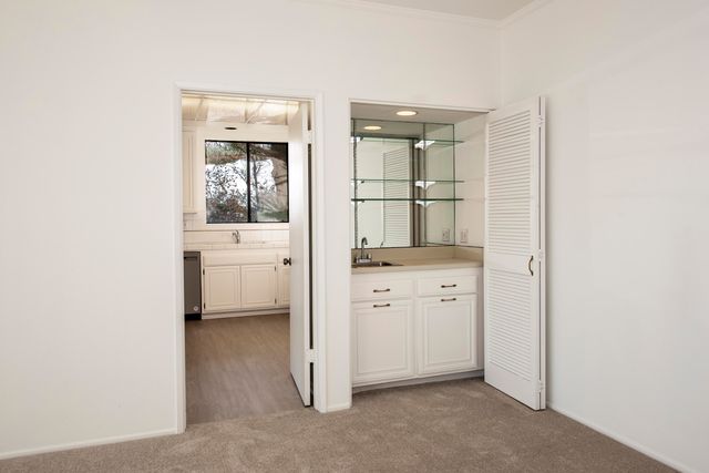 a kitchen with white cabinets and white appliances