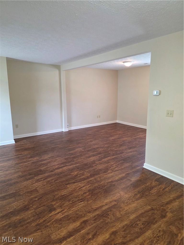 9889 Johnnycake Ridge Road, Unit B Mentor, OH 44060 - Photo 4 of 7 Spacious interior featuring wood-finish flooring, neutral wall tones, and white baseboards