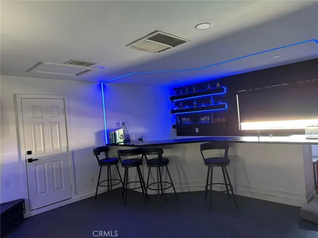 a table room with a table chairs and wooden floor