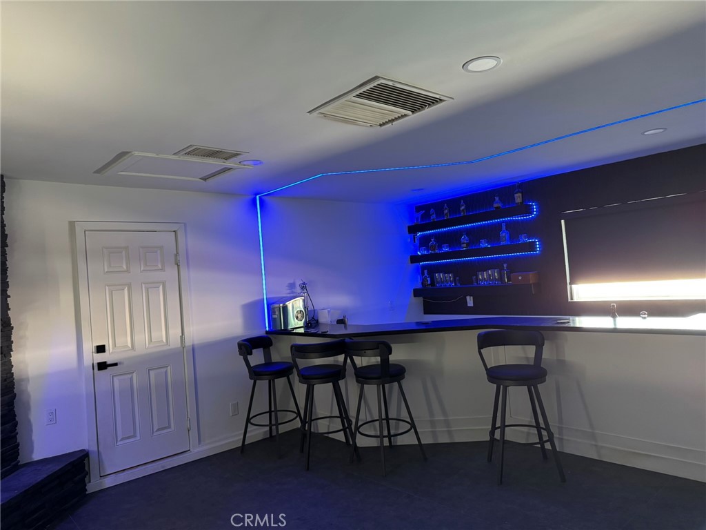 13771 Wawona Road Apple Valley, CA 92307 - Photo 12 of 30 a table room with a table chairs and wooden floor