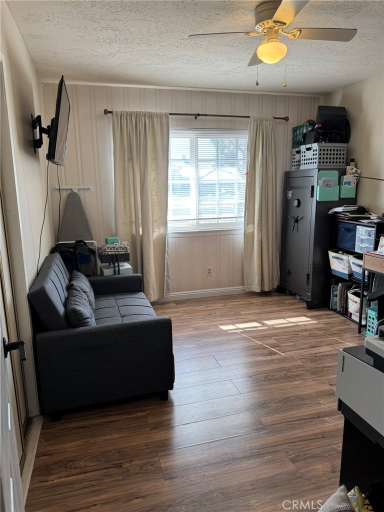13771 Wawona Road Apple Valley, CA 92307 - Photo 16 of 30 a living room with furniture and a wooden floor
