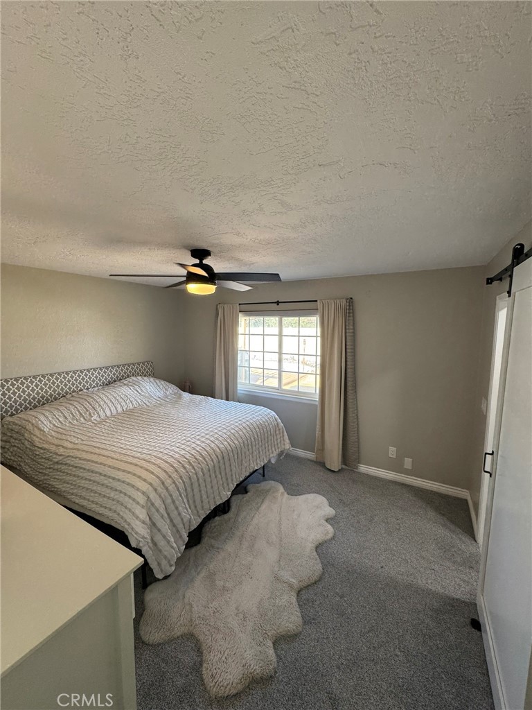 13771 Wawona Road Apple Valley, CA 92307 - Photo 20 of 30 a bedroom with a bed and a window