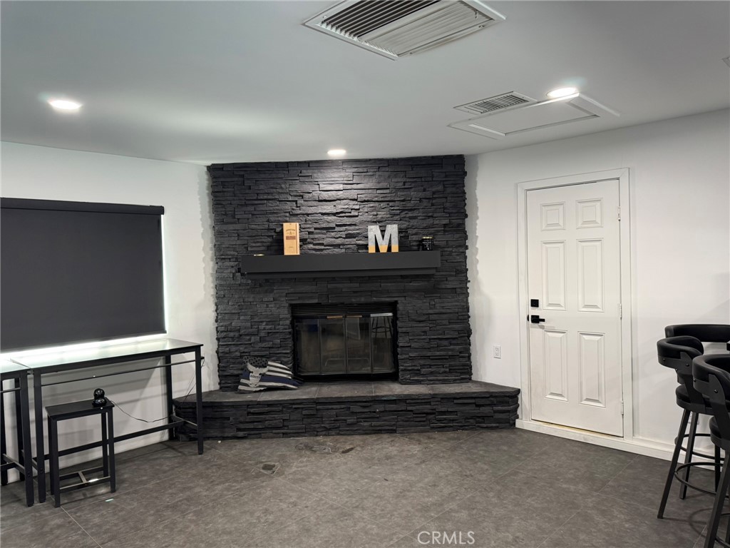 13771 Wawona Road Apple Valley, CA 92307 - Photo 9 of 30 a living room with furniture a flat screen tv and a fireplace