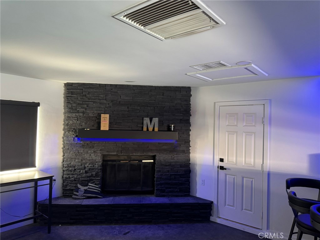 13771 Wawona Road Apple Valley, CA 92307 - Photo 10 of 30 a living room with furniture and a fireplace